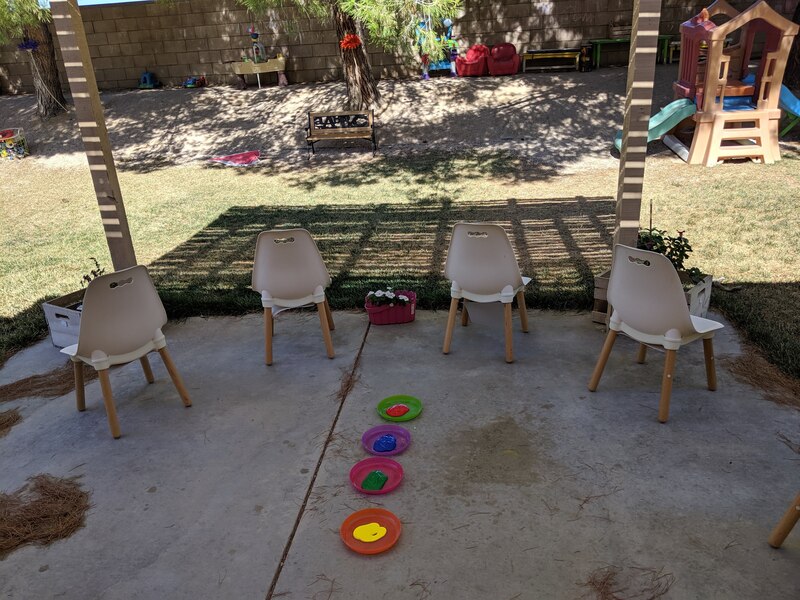 Children learning about outside art with Experience Early Learning
